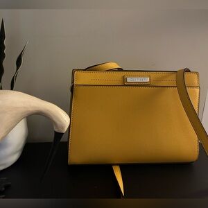 Calvin Klein cross body purse. Excellent condition. Hardly used. Yellow.
